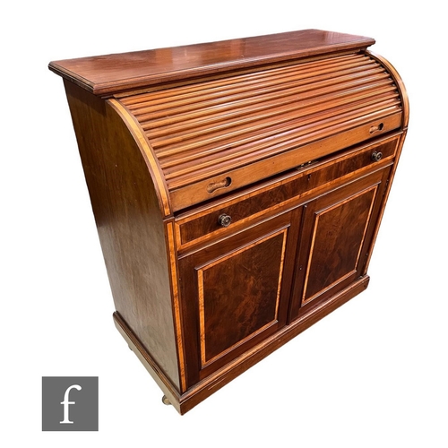 582 - An Edwardian satinwood crossbanded mahogany cylinder desk, the slide out with central lift slope enc... 