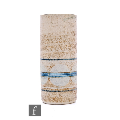 750 - Honor Curtis - Troika Pottery - A cylinder vase decorated with a band of pale blue circles, bisected... 