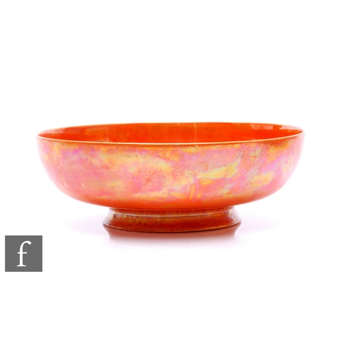 129 - Ruskin Pottery - An early 20th Century orange lustre bowl of circular form, printed and impressed ma... 