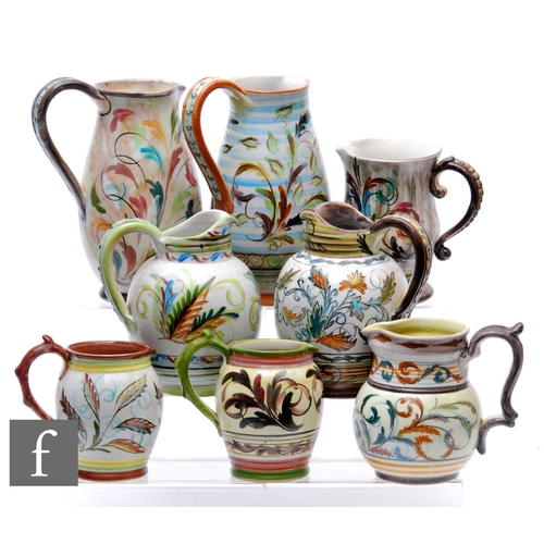 783 - Glyn Colledge - Bourne Denby - A collection of earthenware pitchers and jugs, each decorated with st... 