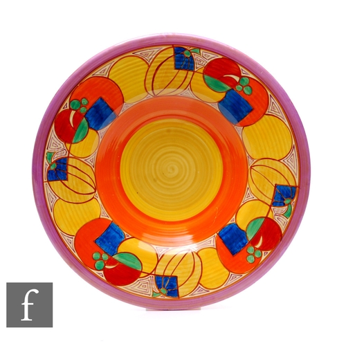 Clarice Cliff - Melon - A large 18 inch ribbed charger circa 1930, radially hand painted with a deep band of abstract fruit with lilac, orange and two tone yellow banding, Fantasque mark, width 45.5cm.