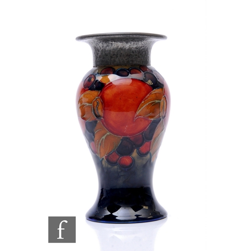 89 - William Moorcroft - Pomegranate - A pewter mounted vase, circa 1925, of inverse baluster form with h... 