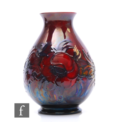 90 - William Moorcroft - Big Poppy - A flambe vase of footed ovoid form, with everted rim, tubeline decor... 