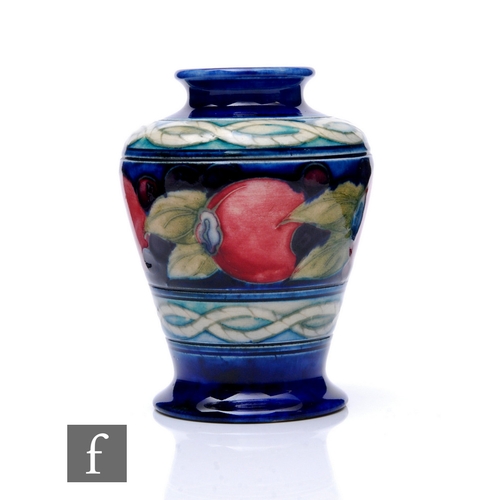 94 - William Moorcroft - Banded Pomegranate - A small shouldered vase, circa 1925, of tapered footed form... 