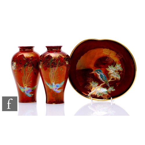 657 - Wilton Ware - A pair of Art Deco vases in the Bird of Paradise pattern, circa 1920s, on a ruby lustr... 