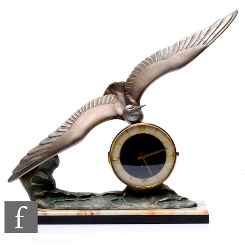 683 - Unattributed maker - An Art Deco mantle clock, the onyx and marble plinth base with circular and gil... 