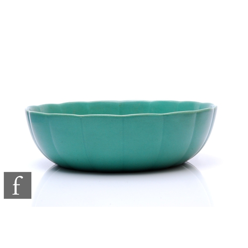 594 - Keith Murray - Wedgwood - An Art Deco green glazed fluted bowl of circular form, printed and impress... 