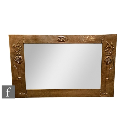 65 - Attributed to Liberty & Co. - A rectangular copper repousse and hammered copper wall mirror, no ... 