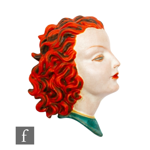 631 - Goldscheider - A 1930s Art Deco wall mask modelled as a female head in profile with orange curled ha... 