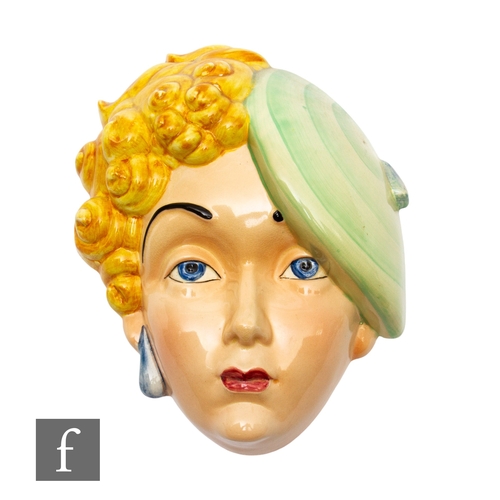 632 - Beswick - An Art Deco wall mask, modelled as a girl with yellow curly hair and green beret, printed ... 