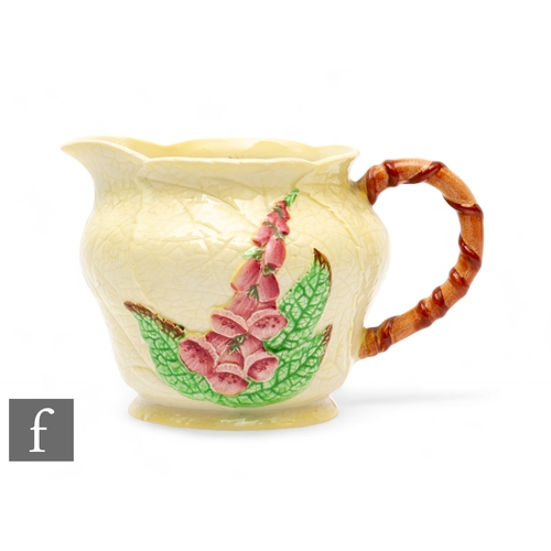 636 - Carlton Ware - An Art Deco Australian Design Foxglove jug, relief moulded with flowers and leaves ov... 