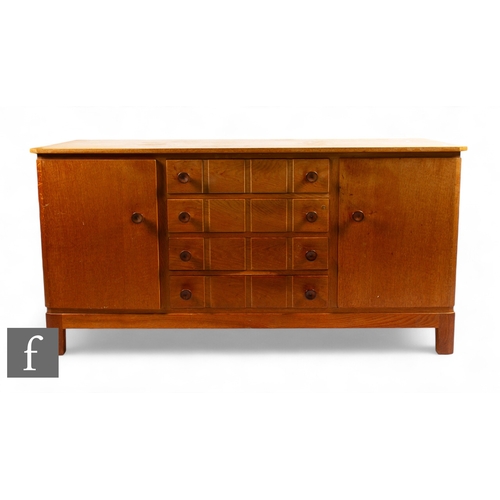 904 - Gordon Russell of Broadway - A 1950s oak 'Utility' sideboard, the four central drawers flanked by tw... 