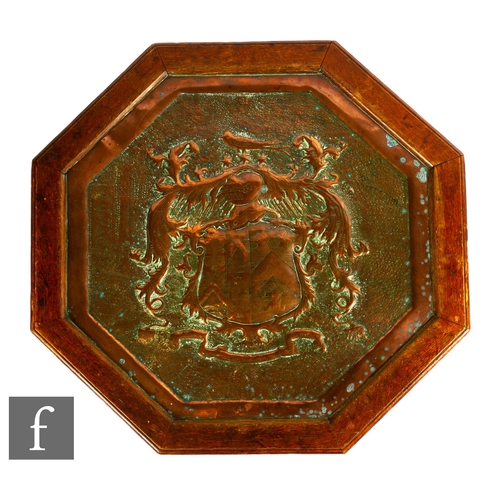 67A - Unattributed maker - An Arts & Crafts octagonal occasional table, with hammered copy heraldic in... 