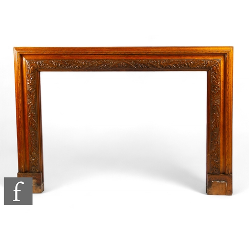 68 - Unattributed maker - A 1930s oak fireplace surround, carved to the front with a series of laurel gar... 