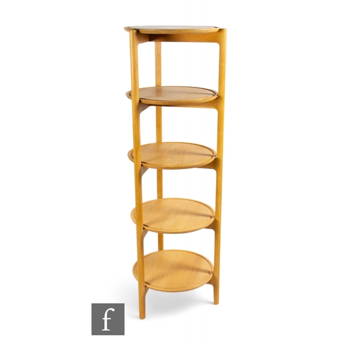 1310 - Ercol - A 'Svelto' open circular shelving unit, the beech frame with five circular shelves, height 1... 