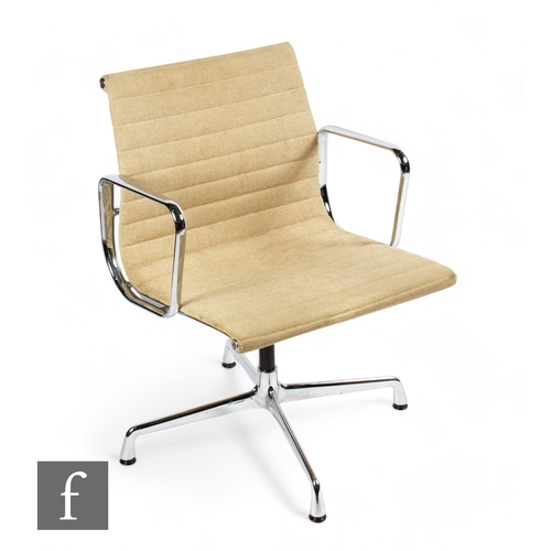 1311 - Charles and Ray Eames - A Vitra aluminium chair, with four-point swivel base, buff coloured fabric, ... 