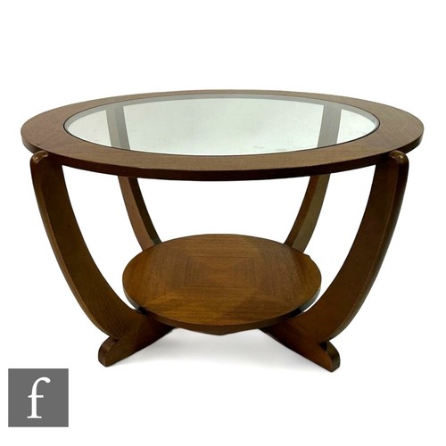 935 - Victor Wilkins - G-Plan - A mid Century 'Astro' coffee table, the glass top raised on four curved su... 