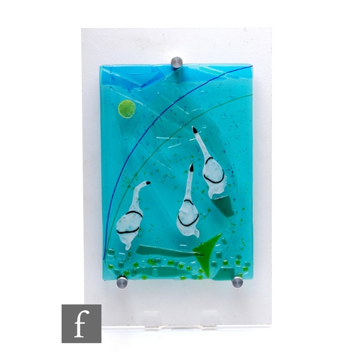 1163 - Myra Wishart - A contemporary studio glass plaque, three swans on moulded blue ground with geometric... 