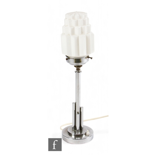 688 - Unattributed maker - An Art Deco table lamp, the chromed base of stepped form with an opal skyscrape... 