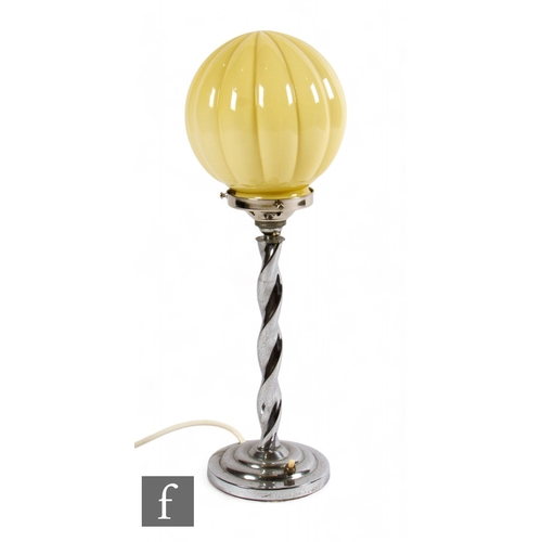 688 - Unattributed maker - An Art Deco table lamp, the chromed base of stepped form with an opal skyscrape... 