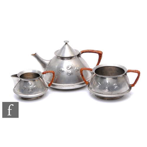 35 - Archibald Knox - Liberty & Co - An early 20th Century pewter tea set, comprising teapot, milk an... 