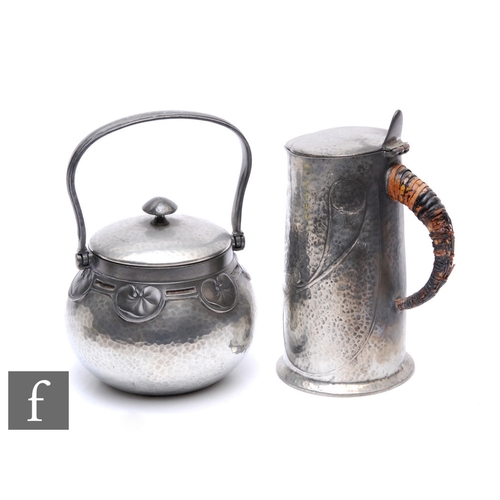 38 - Archibald Knox - Liberty & Co - An early 20th Century pewter jug with a hinged cover and thumbpi... 