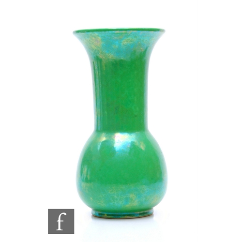 132 - Ruskin Pottery - An apple green lustre vase of ovoid form with drawn neck and everted rim, mottled g... 