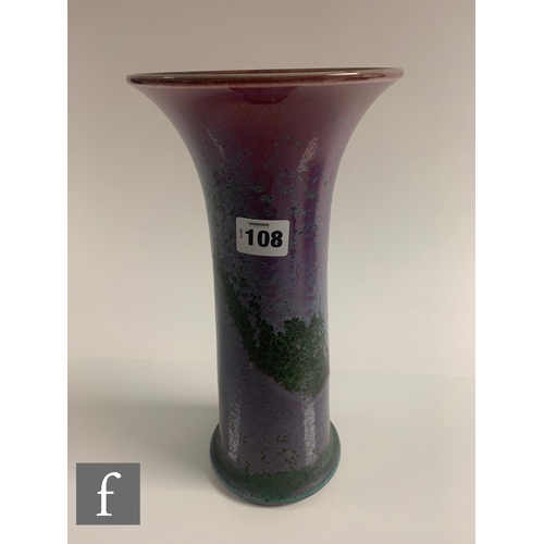 108 - Ruskin Pottery - A high fired Lily vase, of cylindrical flared form, graded deep pink to lilac with ... 