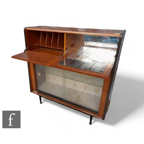 938A - Unattributed maker - A 1950s teak laminated fall front cabinet and bar, with mirrored interior, abov... 