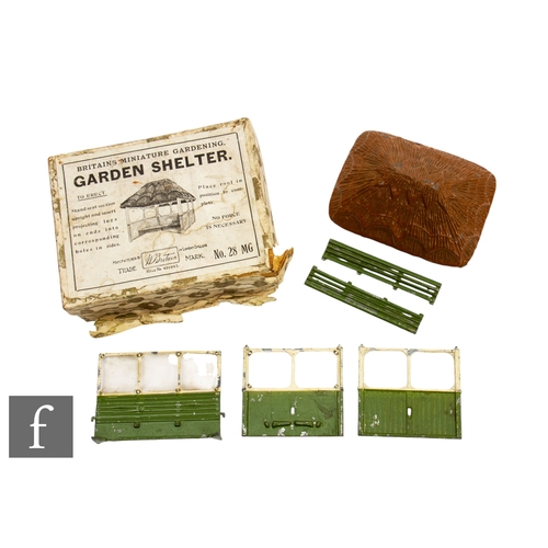 221 - A Britains Miniature Gardening 28MG Garden Shelter, circa 1933-39, comprising thatched roof, central... 