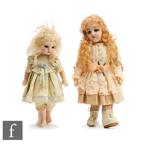 280 - Two reproduction bisque socket head dolls, the first with fixed blue eyes, painted lashes and closed... 