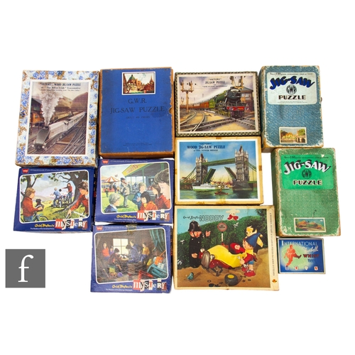 241 - A collection of jigsaw puzzles and games, by Victory and similar, to include GWR such as Silver Link... 