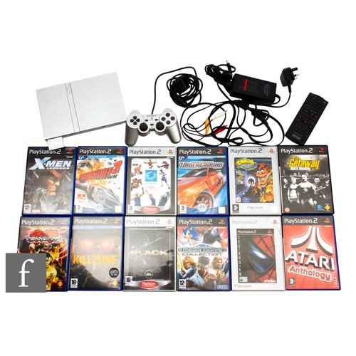 175 - A PlayStation 2 Slim limited edition in silver and controller with a collection of games to include ... 