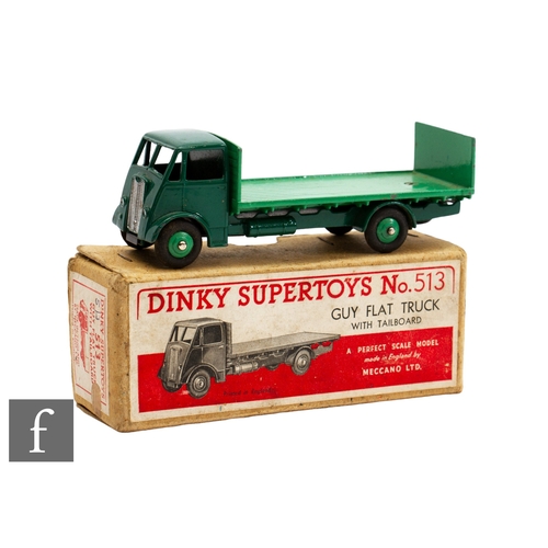 83 - A Dinky 513 Guy Flat Truck with Tailboard, with a Type 1 cab, in two tone green, with buff lift off ... 