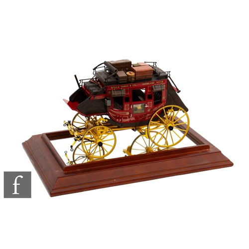 112 - A Franklin Mint 1:16 Wells Fargo Overland Stagecoach, with certificate and display case.