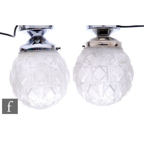 691 - Pierre Maynadier - A pair of 1930s Art Deco chrome and frosted glass ceiling lights, the spherical f... 