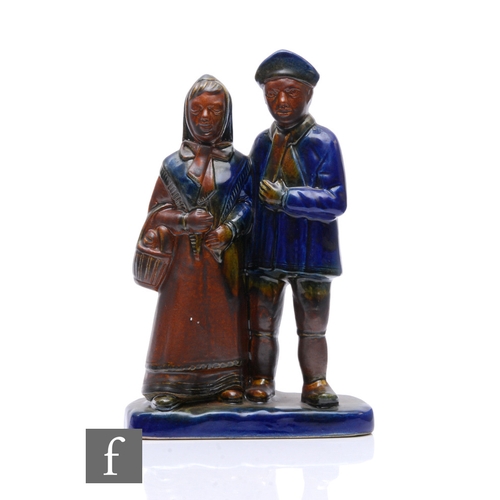 1129 - Bay Keramik - A later 20th Century salt glazed figural group, circa 1983, depicting a couple, he hol... 