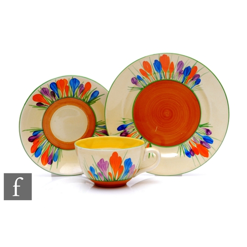 528 - Clarice Cliff - Crocus - A Globe shape teacup, saucer and side plate circa 1929, hand painted with C... 