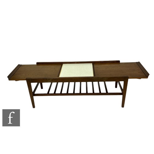 933 - Remploy - A mid Century teak extending cover table, with pull out top and magazine rack below, heigh... 