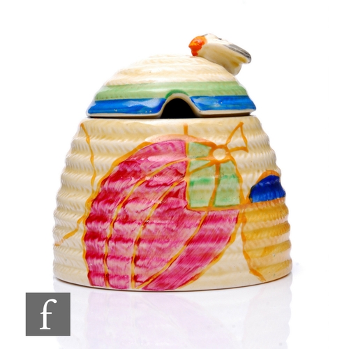 376 - Clarice Cliff - Pastel Melon - A large Beehive honey pot circa 1932, hand painted with a band of sty... 