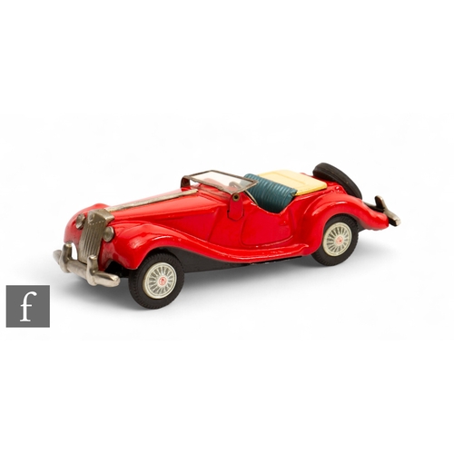 159 - A Japanese Bandai tinplate friction drive MG TF Sports Car, finished in metallic red, with cream fol... 