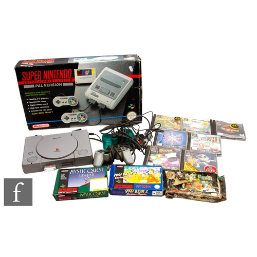 181 - A boxed Super Nintendo Entertainment System (SNES), with a small selection of games, together with a... 