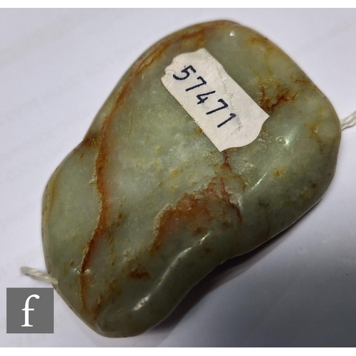 502 - A Chinese Qing Dynasty jade pebble carving, the smooth pale green and russet stone, carved in relief... 