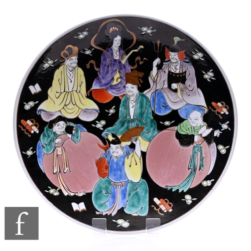 500 - A 20th Century Japanese charger, the black ground decorated with immortal gods, diameter 40cm.