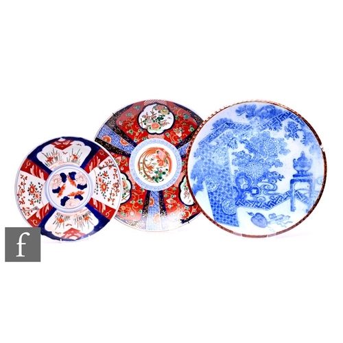 518 - Three Japanese chargers, Imari and blue and white examples, diameters ranging 31cm- 41cm. (3)