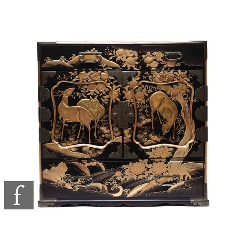 521 - A Late Meiji period (1868-1912) Tansu (storage cabinet), the table top black lacquered cabinet with ... 