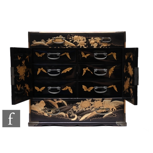 521 - A Late Meiji period (1868-1912) Tansu (storage cabinet), the table top black lacquered cabinet with ... 