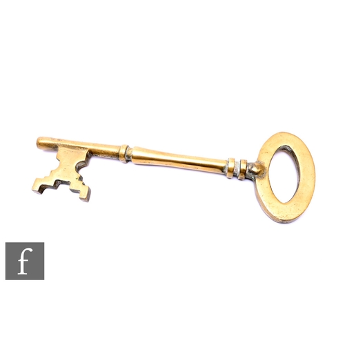 35 - A large brass key, width 35.5cm.