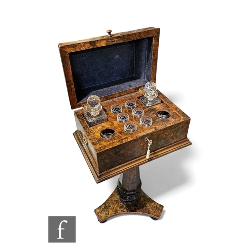 80 - A 19th Century burr walnut decanter stand, the caddy top opening to reveal a compartmentalised inter... 