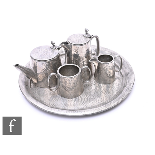 86 - A 1930s or later five piece hammered pewter tea service, comprising a teapot, hot water jug, milk ju... 